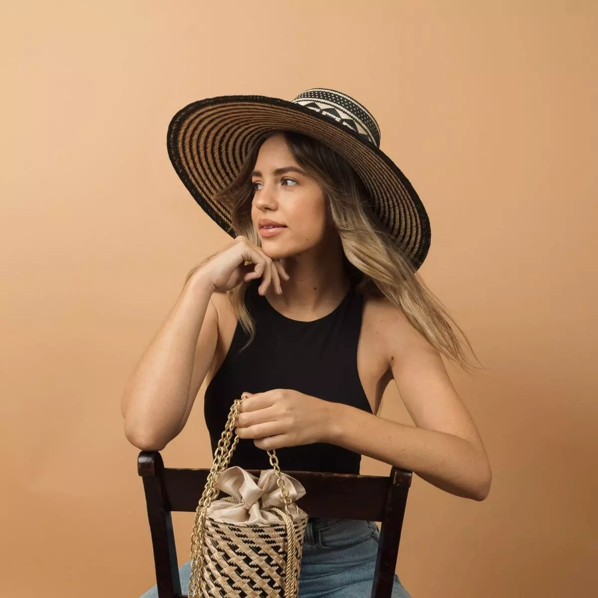 a women wearing Black wide brim straw hat