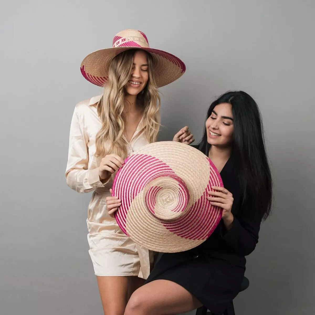 Two women wearing Yonna Fuchsia Wide Brim Straw Hat