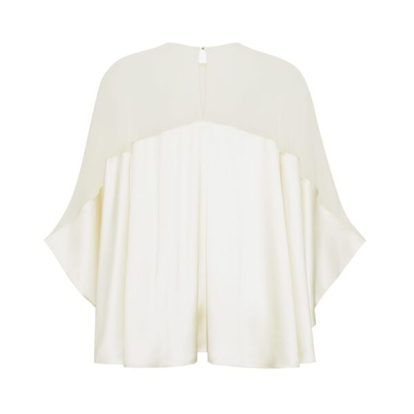 the Apollo Top is crafted from luxurious 100% silk in a soft cream hue. The flowing