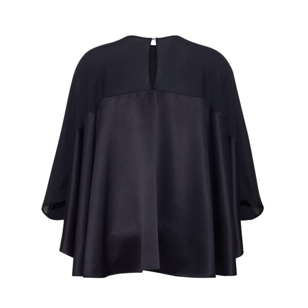 the Apollo Top is crafted from luxurious 100% silk in a timeless black hue. The flowing