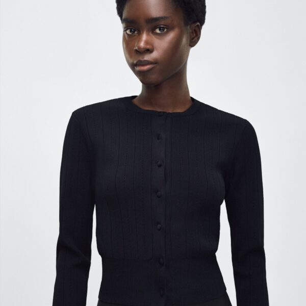 the piece is finished with covered buttons along the front placket for a refined look.
