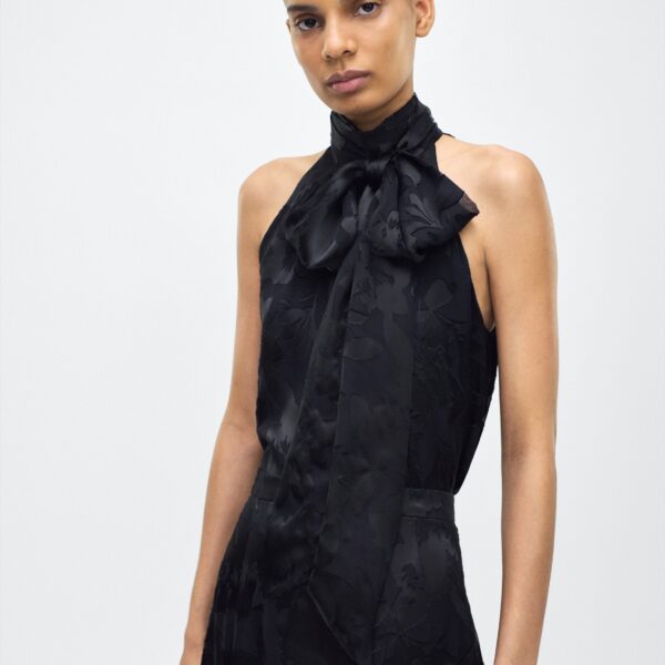 while the flowing silhouette exudes sophistication. Pair with the Emi Skirt in Devore for a coordinated ensemble.