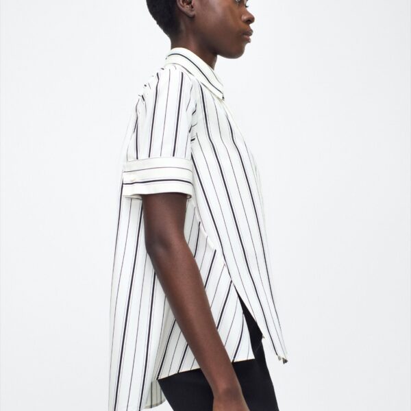 collar stand and French cuffs. Designed with side slits for a breezy
