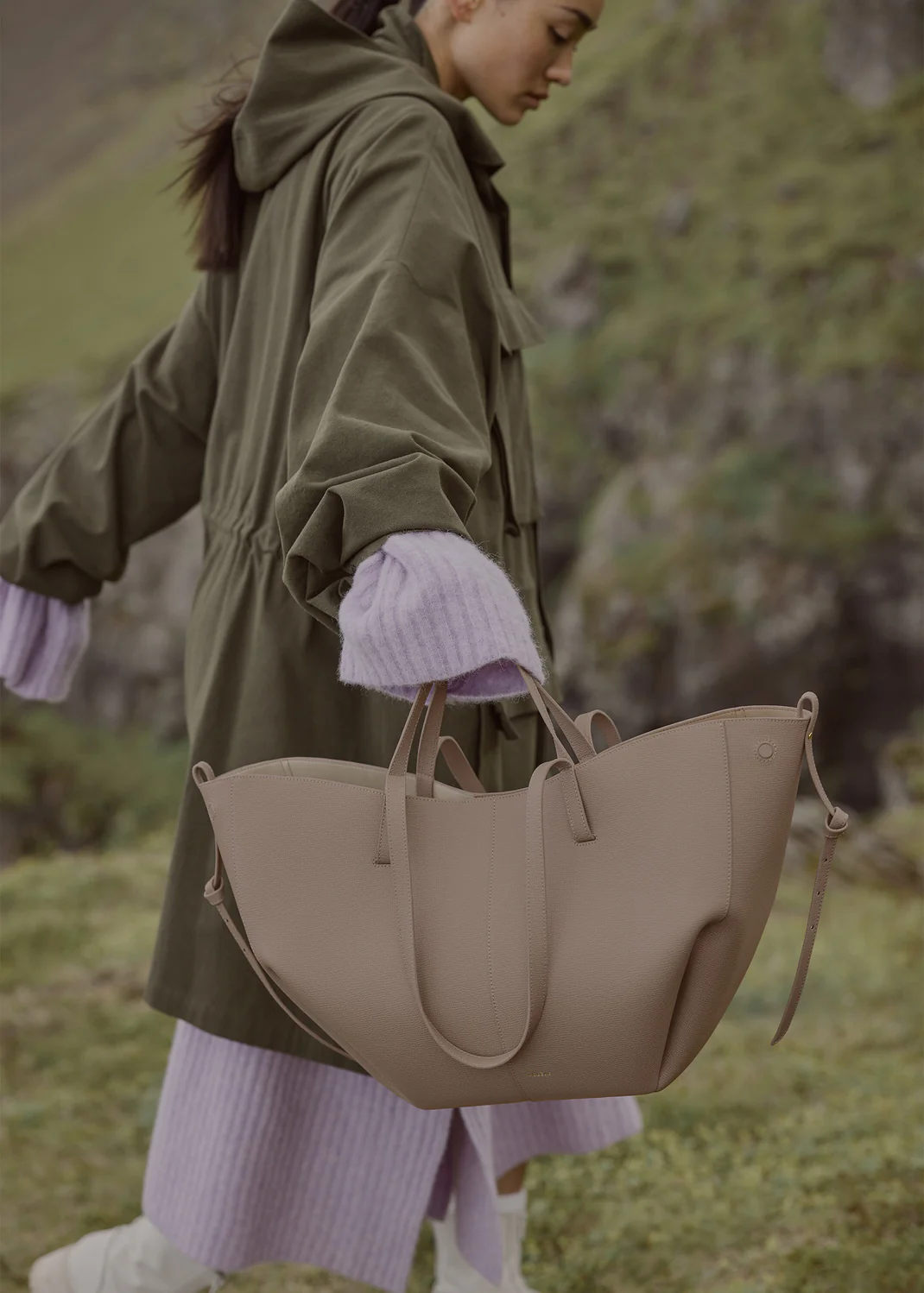 Taupe Cyme Edition bag by Polène on neutral set backdrop