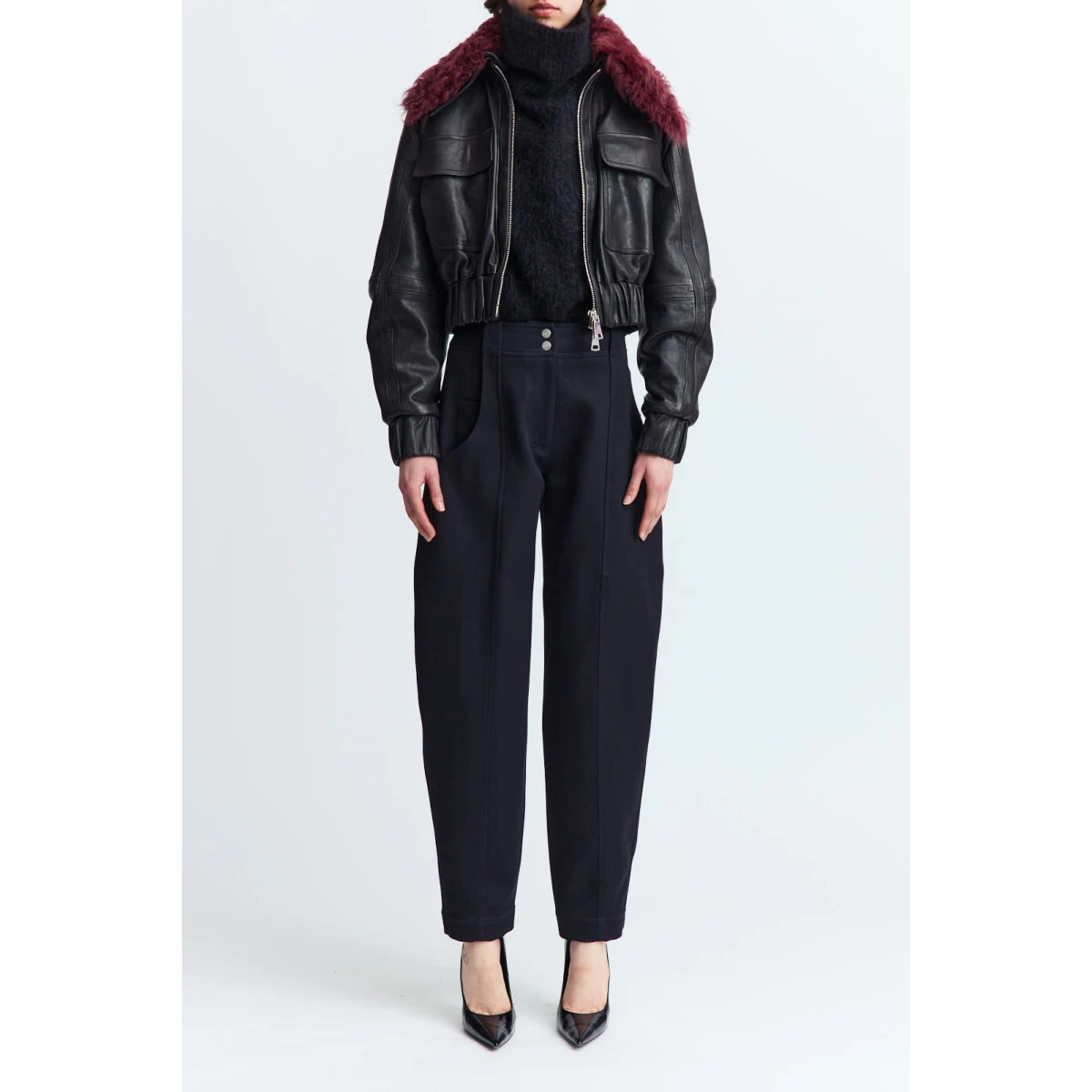 designed with a double zip closure and a cinched waist for subtle structure. It features two oversized flap pockets at the chest and a detachable sheerling collar that adds warmth and texture.