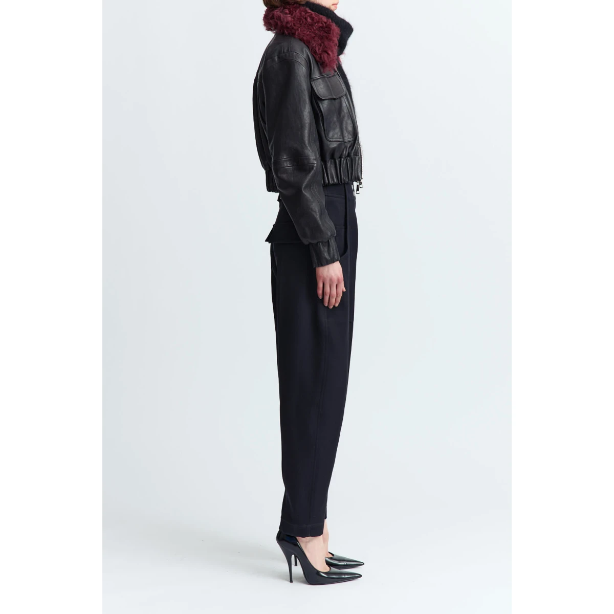 designed with a double zip closure and a cinched waist for subtle structure. It features two oversized flap pockets at the chest and a detachable sheerling collar that adds warmth and texture.
