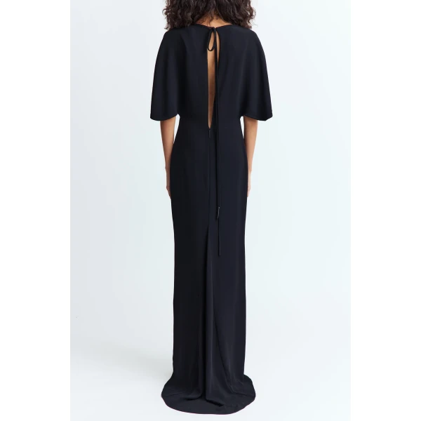 cape like sleeves that fall softly over the shoulders and a tapered waist that defines the form.