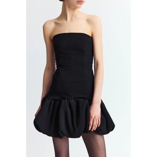 designed to sit close to the body. Strapless and fitted through the bodice