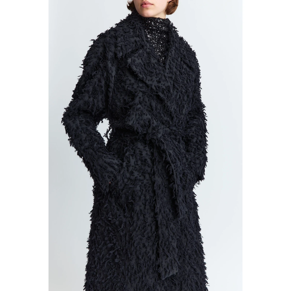 detailed with subtle tasseling throughout. It features a structured collar
