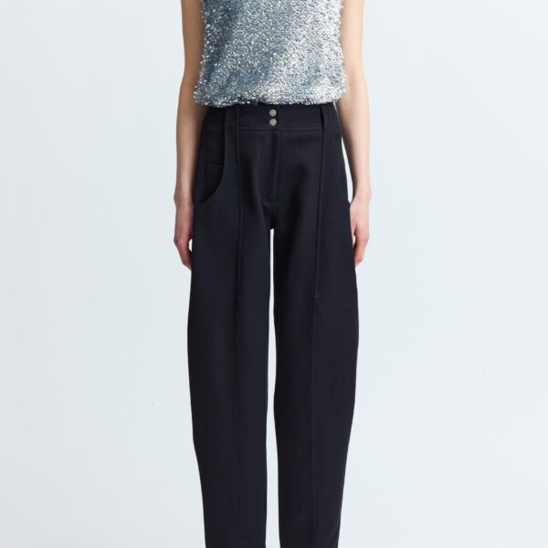 lending structure and elongation to the silhouette. It features four pockets - two at the front and two at the back - along with three buttons at the rear and belt loops at the waist. A refined take on classic tailoring with a sculptural twist.