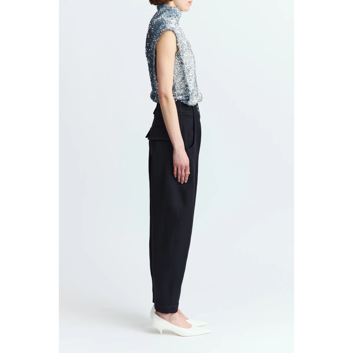 lending structure and elongation to the silhouette. It features four pockets - two at the front and two at the back - along with three buttons at the rear and belt loops at the waist. A refined take on classic tailoring with a sculptural twist.