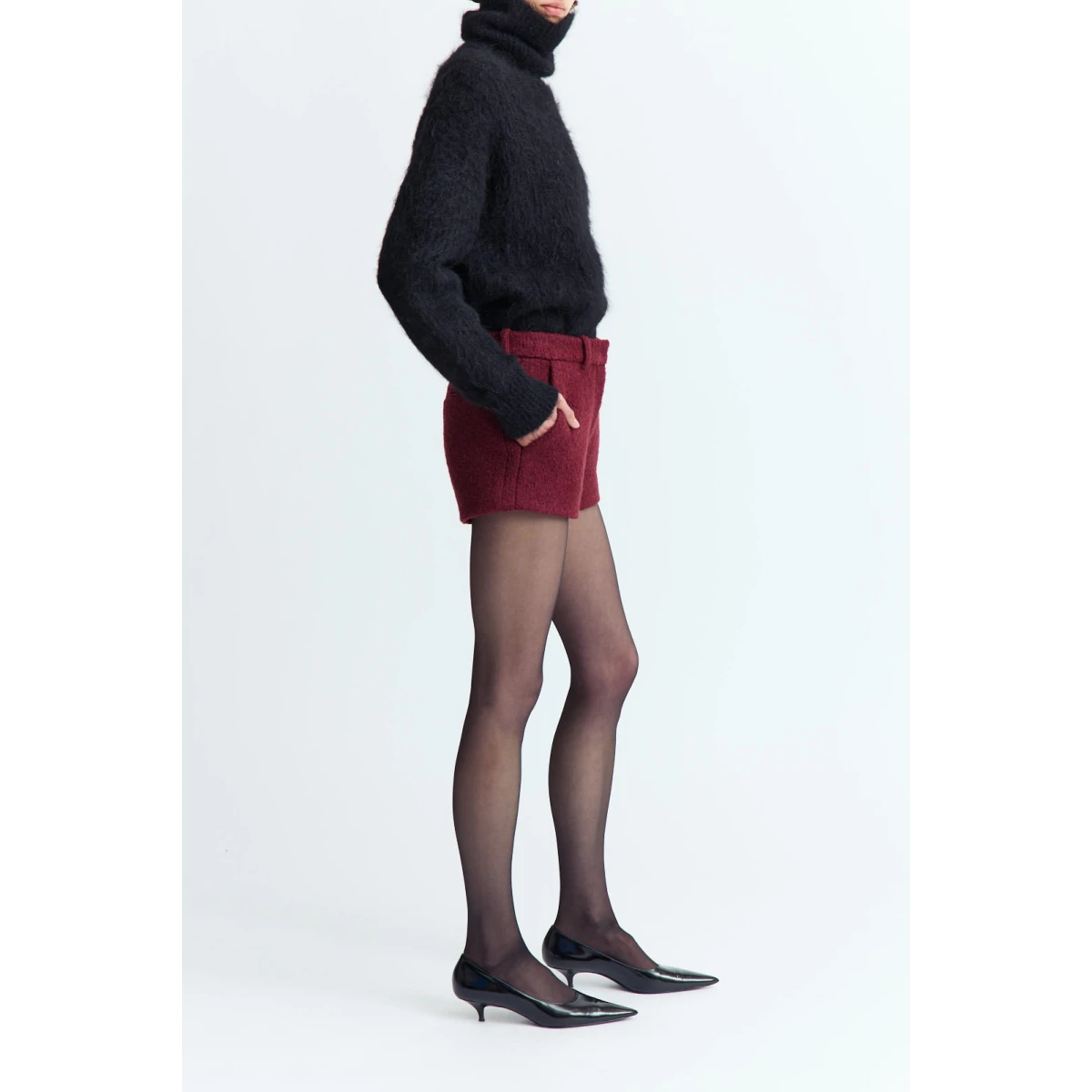 and subtle texture. It features a high roll neck and a gently relaxed shape
