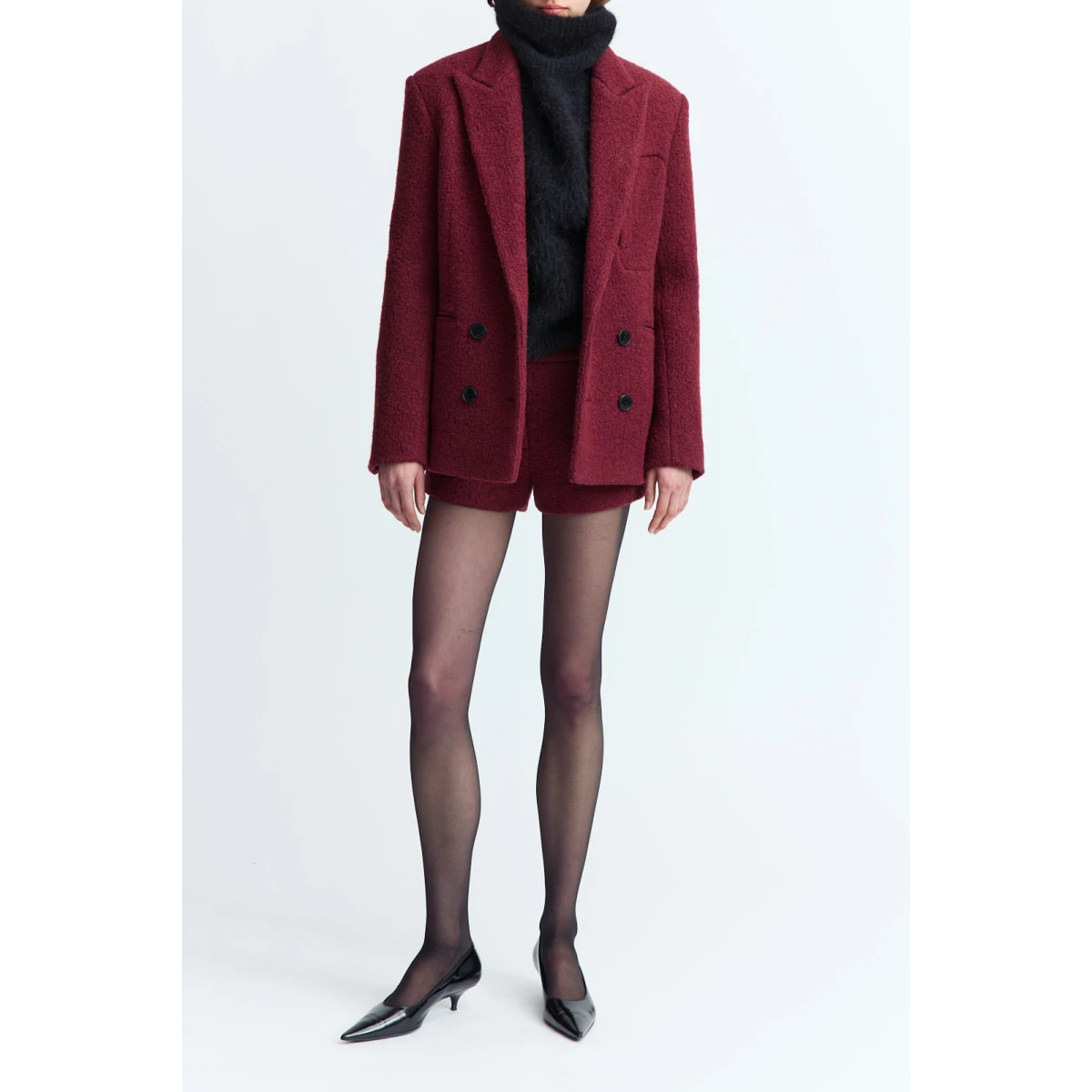 offering soft texture with a structured finish. It features two flap pockets at the sides and a single welt pocket at the breast