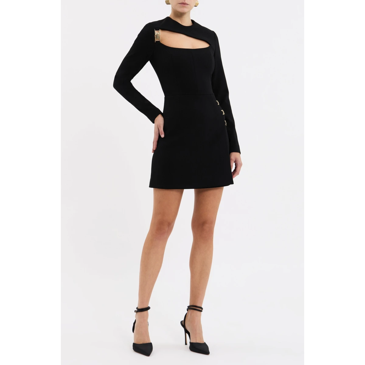 accentuated by a cinched waist. The elegant wrap mini skirt is adorned with gold art deco trim