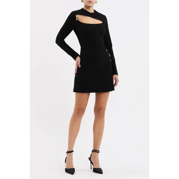 accentuated by a cinched waist. The elegant wrap mini skirt is adorned with gold art deco trim