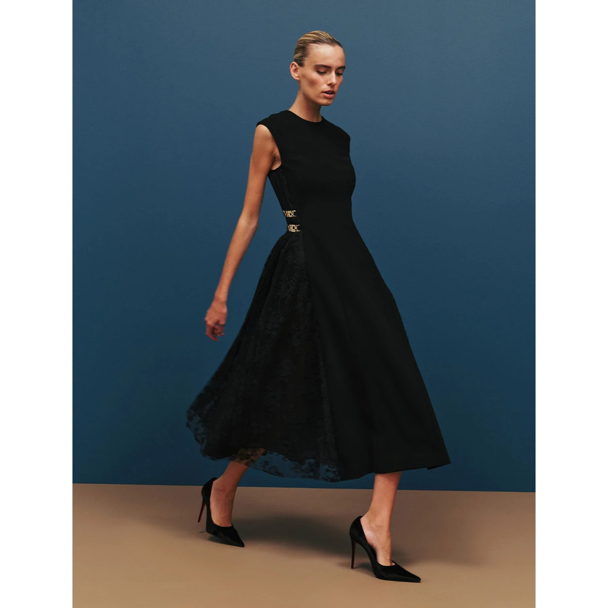 detailed with intricate lace panels and art deco chains at the sides for a touch of opulence. Complete with an invisible zip fastening at the back