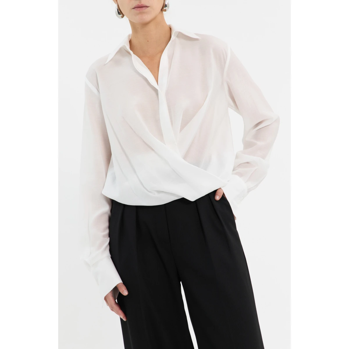 Rebecca Vallance White Tops The Noor Top in ivory embodies refined elegance and timeless sophistication. It features a chic twist-detail front