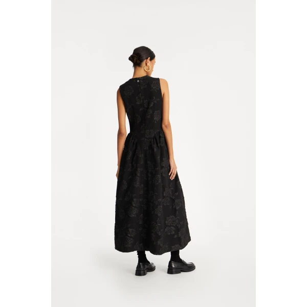 Rotate Black from Coveti – bold silhouette in vibrant color