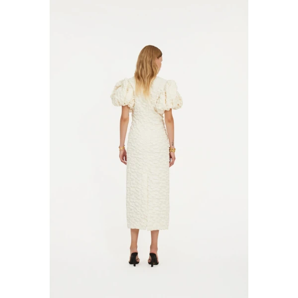 Rotate White from Coveti – bold silhouette in vibrant color