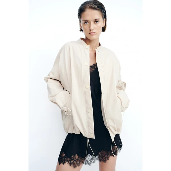 Adjustable elastic at sleeve hem with toggles