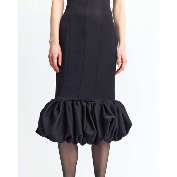 It features a square neckline framed by slender straps