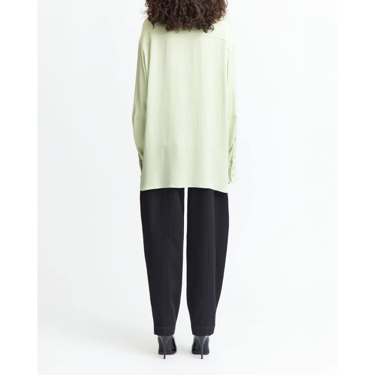 It features an exaggerated collar that sharpens the silhouette