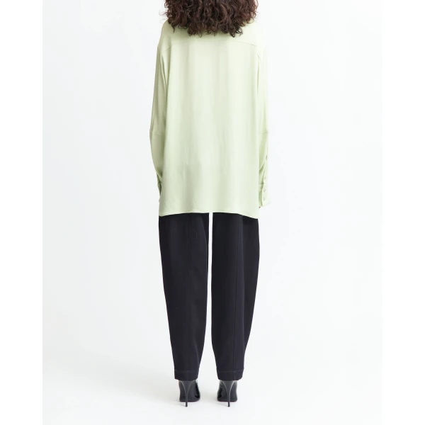 It features an exaggerated collar that sharpens the silhouette