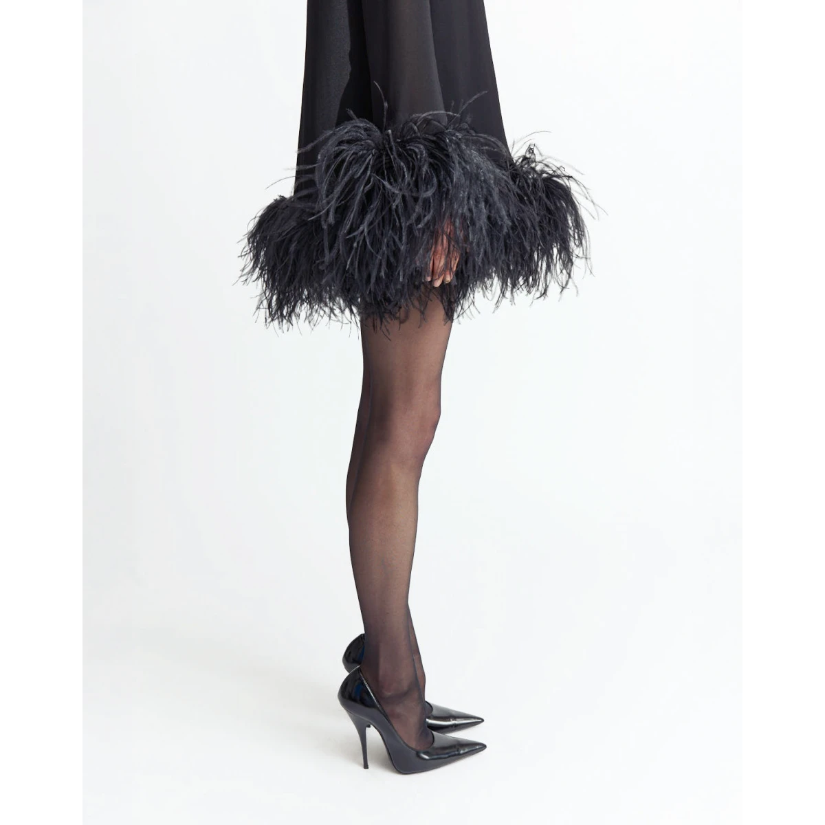 it’s finished with feathered detailing at the wrists and hem