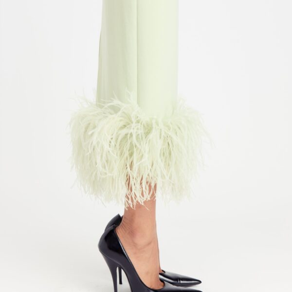 it finishes with a feathered hem that adds delicate movement and unexpected texture to the sleek silhouette.