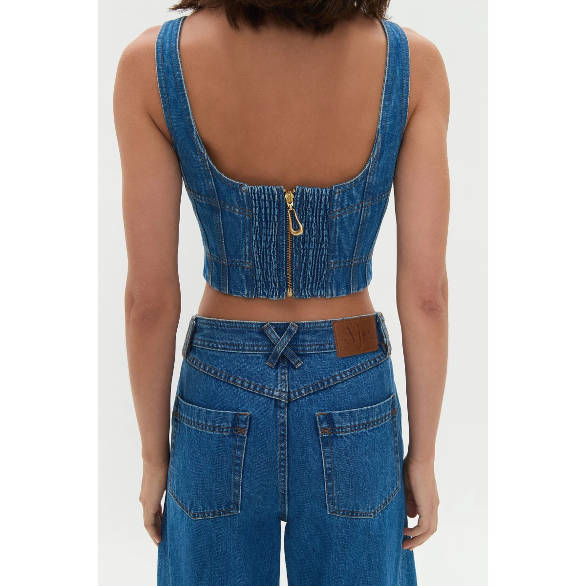 Aje clothing Aus Tops – structured silhouette with raw femininity from Coveti
