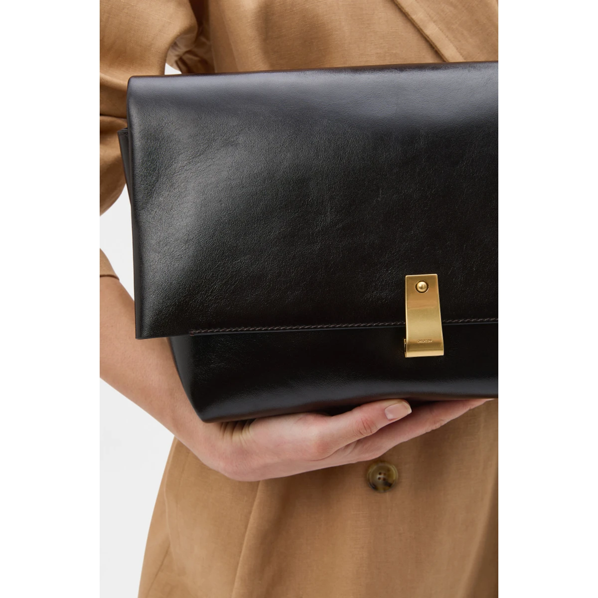 Profile view of model wearing the Oroton ETTA LARGE CLUTCH in DARK CHOCOLATE and Premium crackle leather for Women