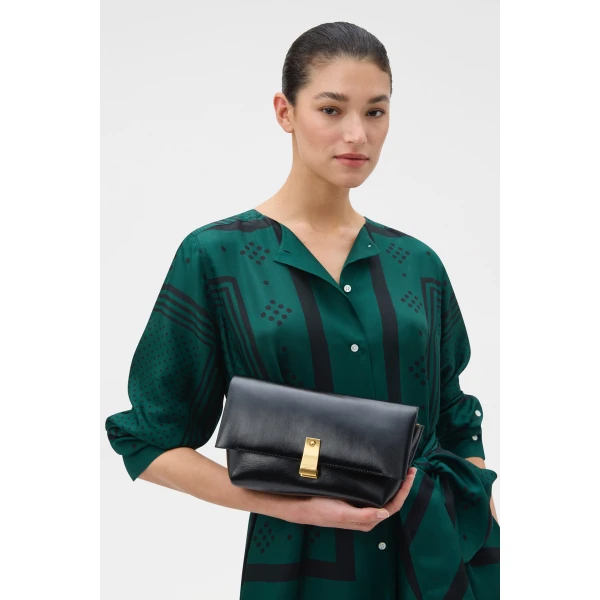 Profile view of model wearing the Oroton ETTA MEDIUM CLUTCH CRACKLE in BLACK and Premium crackle leather for Women