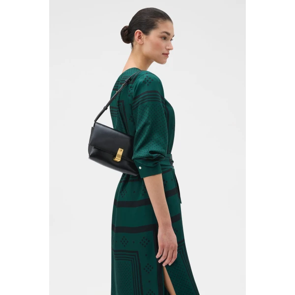 Profile view of model wearing the Oroton ETTA MEDIUM CLUTCH CRACKLE in BLACK and Premium crackle leather for Women