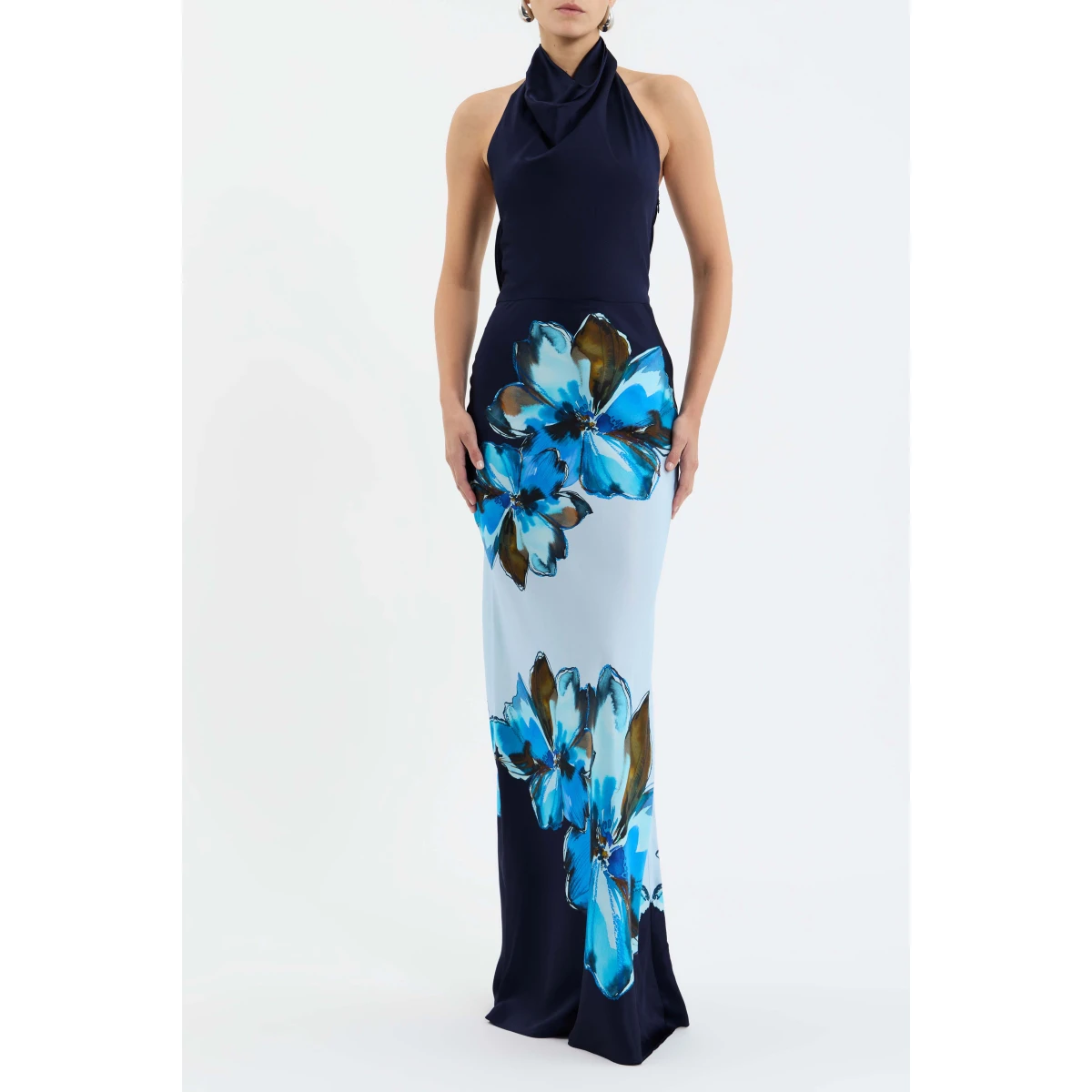 crafted from silk. The halter cowl neckline and open back add a touch of allure