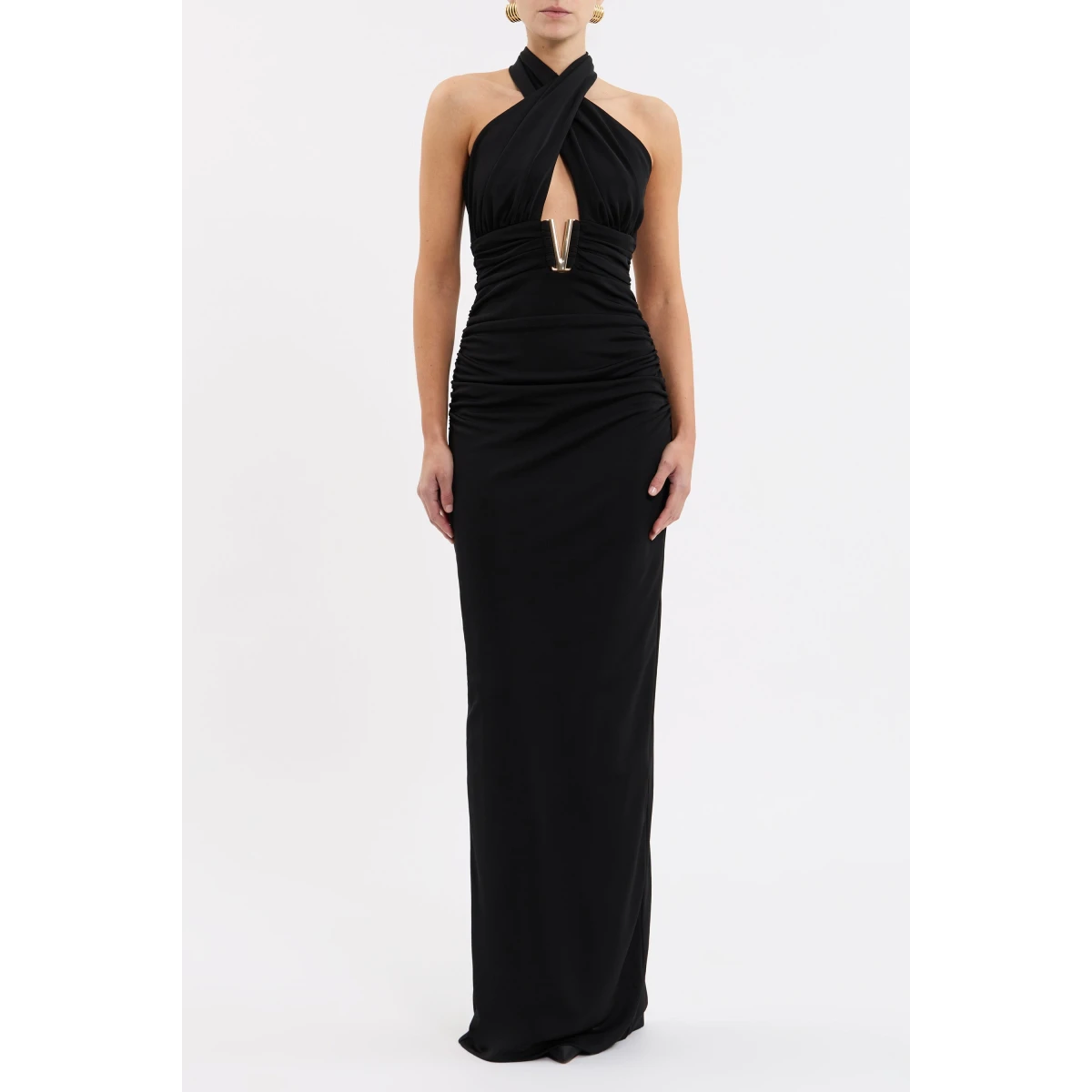 tailored from premium jersey. The twisted halter neckline and gathered bodice feature a front cut out adorned with a gold V trim