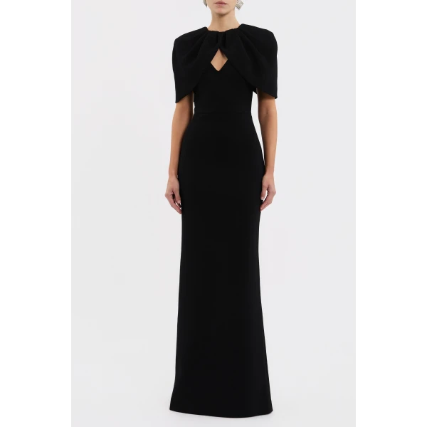 it features a striking draped cape overlay that harmonises with the V neckline and fitted bodice