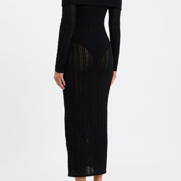feminine silhouette. The off the shoulder neckline and long sleeves add a refined touch