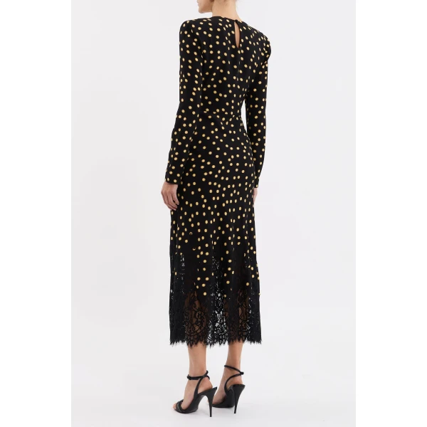 adding a touch of chic style to the design. Long fitted sleeves with invisible zip fastenings offer ease of wear