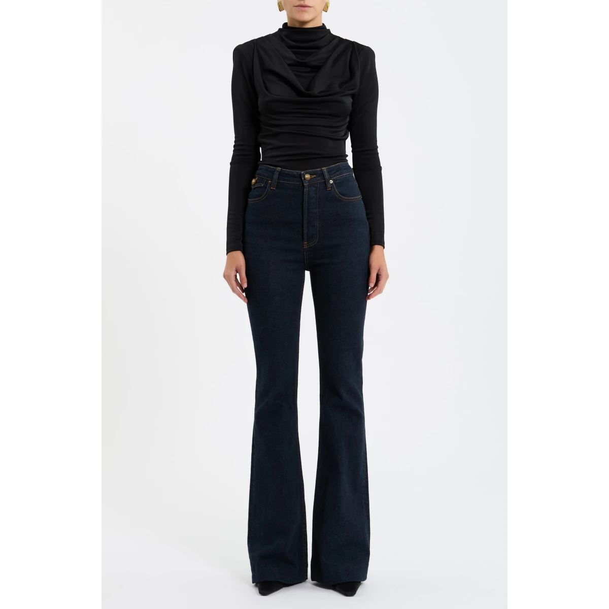 its cowl turtle neckline and fitted bodice shape a sophisticated silhouette