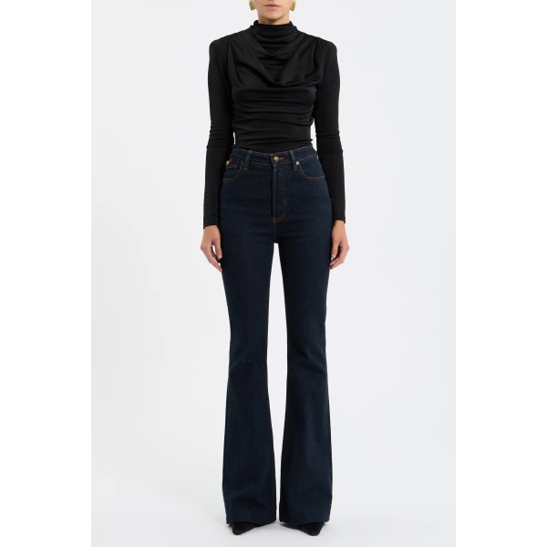 its cowl turtle neckline and fitted bodice shape a sophisticated silhouette