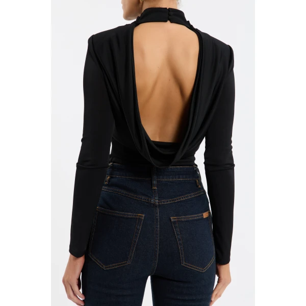 its cowl turtle neckline and fitted bodice shape a sophisticated silhouette