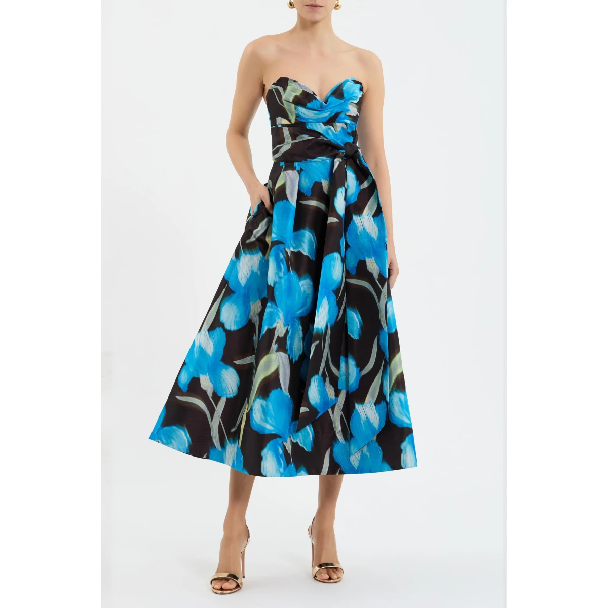 the design is elevated with a draped bustier and a front waist tie for a modern