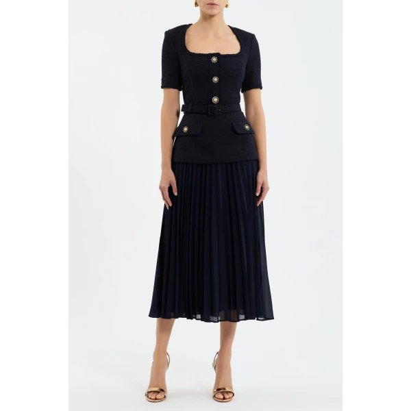 detailed with braided trims and gold hardware buttons. Princess seams and front flap pockets elevate the chic design