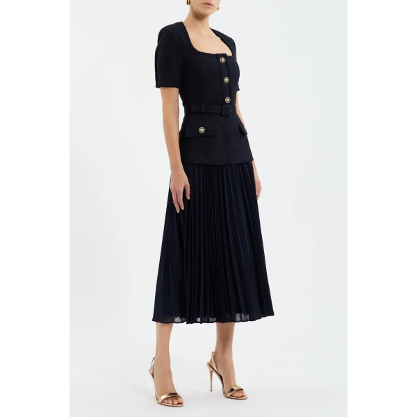while a sheer georgette pleated midi skirt creates a graceful silhouette. Polished and refined