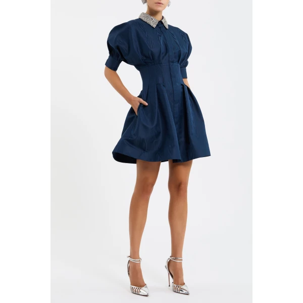 the voluminous short puff sleeves with cuffs and fitted waist offer an elegant look