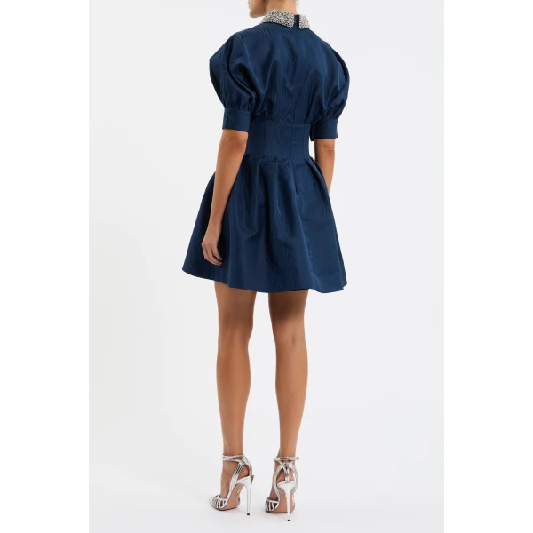 complemented by a circular mini skirt that shapes a flattering silhouette. Side seam pockets and a concealed placket complete the polished design