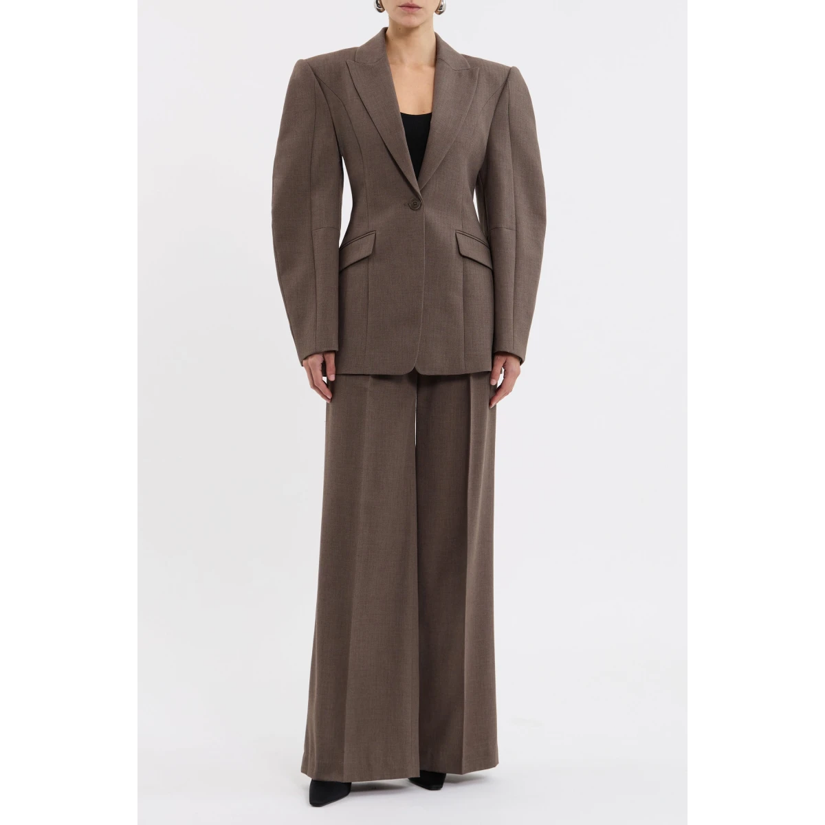 the bold cocoon long sleeves and shoulder pads sculpt an eye-catching silhouette