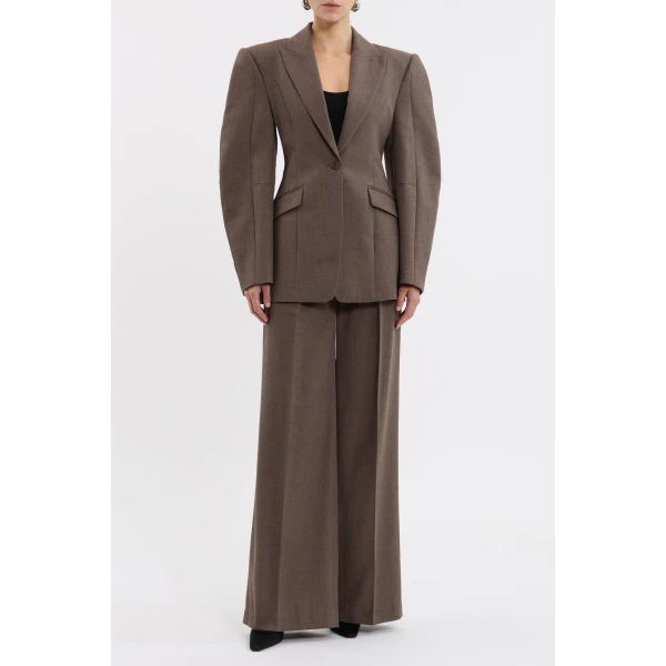 the bold cocoon long sleeves and shoulder pads sculpt an eye-catching silhouette