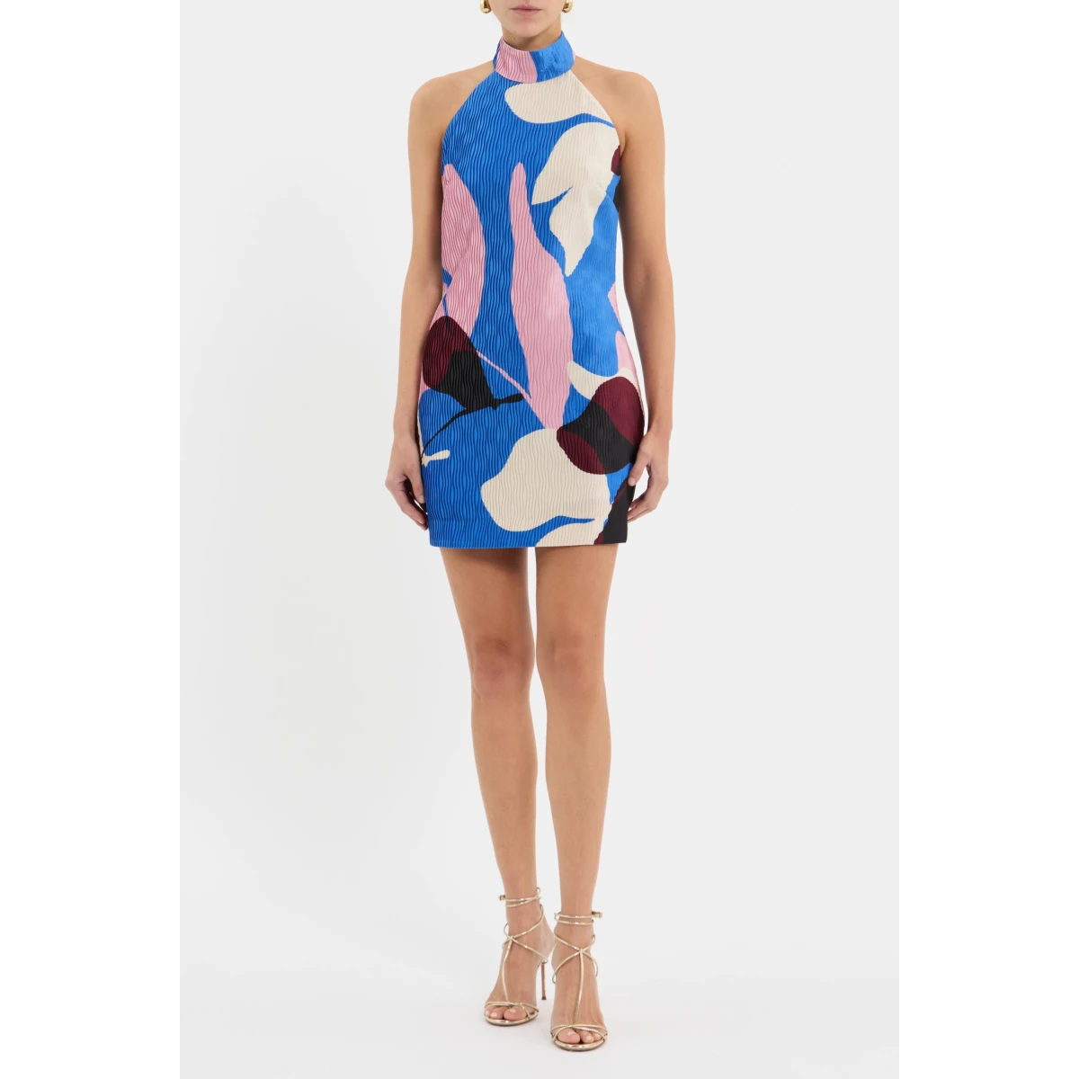 the design is elevated by a low open back that enhances its feminine slip silhouette. An invisible zip fastening at the back completes the refined look