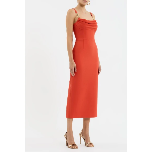 it features a cowl bust neckline and a fitted bodice that shape a feminine silhouette